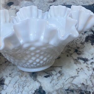 This is a Vintage Fenton Hobnail Milk Glass Ruffled Edged Bowl. Approx 9”W x 4”H